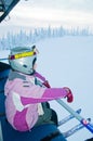 Little girl-skier on the ski lift