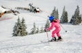 Little girl skiing fast downhill