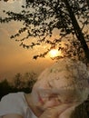 Little girl sleeping and beautiful sunset landscape, double exposure effect. Sweet dreams concept