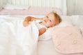 Little girl sleeping in bed in bedroom with crown. Princess birthday party. Royalty Free Stock Photo