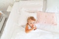 Little girl sleeping in bed in bedroom with crown. Princess birthday party. Royalty Free Stock Photo