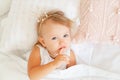 Little girl sleeping in bed in bedroom with crown. Princess birthday party. Royalty Free Stock Photo