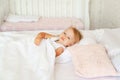 Little girl sleeping in bed in bedroom with crown. Princess birthday party. Royalty Free Stock Photo