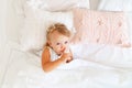 Little girl sleeping in bed in bedroom with crown. Princess birthday party. Royalty Free Stock Photo