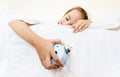 Little girl sleeping and holding alarm clock in hand Royalty Free Stock Photo