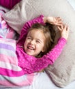 Little girl sleeping in a pink bed