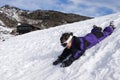 Little girl slide on snow during winter holiday Royalty Free Stock Photo