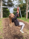 Little girl sliding down a zip line