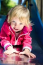 Little girl sliding from the plastic chute Royalty Free Stock Photo