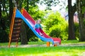 Little girl sliding on a playground Royalty Free Stock Photo