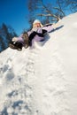 Little girl sliding in the snow Royalty Free Stock Photo