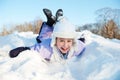 Little girl sliding in the snow Royalty Free Stock Photo