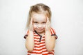 Little girl with sly smile slightly covers her face Royalty Free Stock Photo