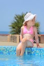 Little girl smeared with cream for sunburn on pool Royalty Free Stock Photo