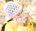 Little girl smelling flowers outdoors Royalty Free Stock Photo