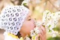 Little girl smelling flowers outdoors Royalty Free Stock Photo