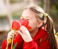 Little girl smelling flowers outdoors Royalty Free Stock Photo