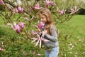 A little girl smelling a pink magnolia Royalty Free Stock Photo