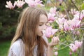 little girl smelling pink magnolia Royalty Free Stock Photo