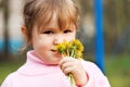 The little girl smells flowers