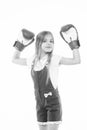 Little girl smile after boxing training isolated on white. Happy child raised hands in boxing gloves. Punching Royalty Free Stock Photo