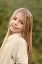 Little girl smile with long blond hair. Child with cute face outdoor. Beauty kid with fresh look and skin. Beauty look Royalty Free Stock Photo