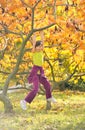 Little girl smiling and hanging on a branch