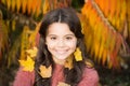 Little girl smiling happy cute child gorgeous long hair maple leaves. Cozy autumn day. Play with leaves. Happy childhood
