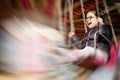 Little girl smiling while riding a carrousel; intentional motion blur effect Royalty Free Stock Photo