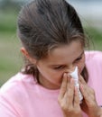 Little girl sneezing her nose because of allergy Royalty Free Stock Photo