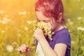 Little girl sniffs flowers