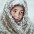 A little girl in a snow-covered shawl