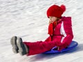Little girl with snow sleds