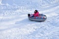 Little girl snow tubing