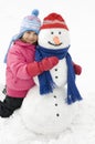 Little girl and snowman Royalty Free Stock Photo