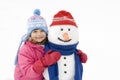 Little girl and snowman Royalty Free Stock Photo