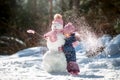 Little girl with snowman Royalty Free Stock Photo