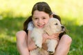 Little girl snuggling a puppy. Royalty Free Stock Photo