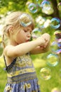 Little girl with soap bubbles