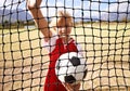 Little girl, soccer player and ball on goal net, smile and happy for game, field and child. Outdoor, playful or sport Royalty Free Stock Photo