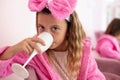 Little girl in spa center having a party and drinking a drink.  Kids in spa center. Royalty Free Stock Photo