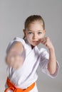 Little girl sparring, punch in karate, close-up portrait