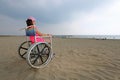 Little girl on the special wheelchair with big wheels in alumini