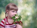 Little girl with sprigs of red currants