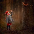 Little girl with squirrel in an autumn forest