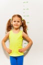 Little girl stand by measuring height scale Royalty Free Stock Photo