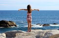 Little girl standing at cliff at ocean front in Los Cabos Mexico resort cliff sea Royalty Free Stock Photo