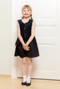 A little girl is standing by the door. Royalty Free Stock Photo