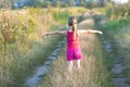 Little girl standing on a field road on a summer sunset evening Royalty Free Stock Photo