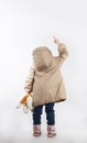 A little girl standing with his back pointing her finger. Royalty Free Stock Photo